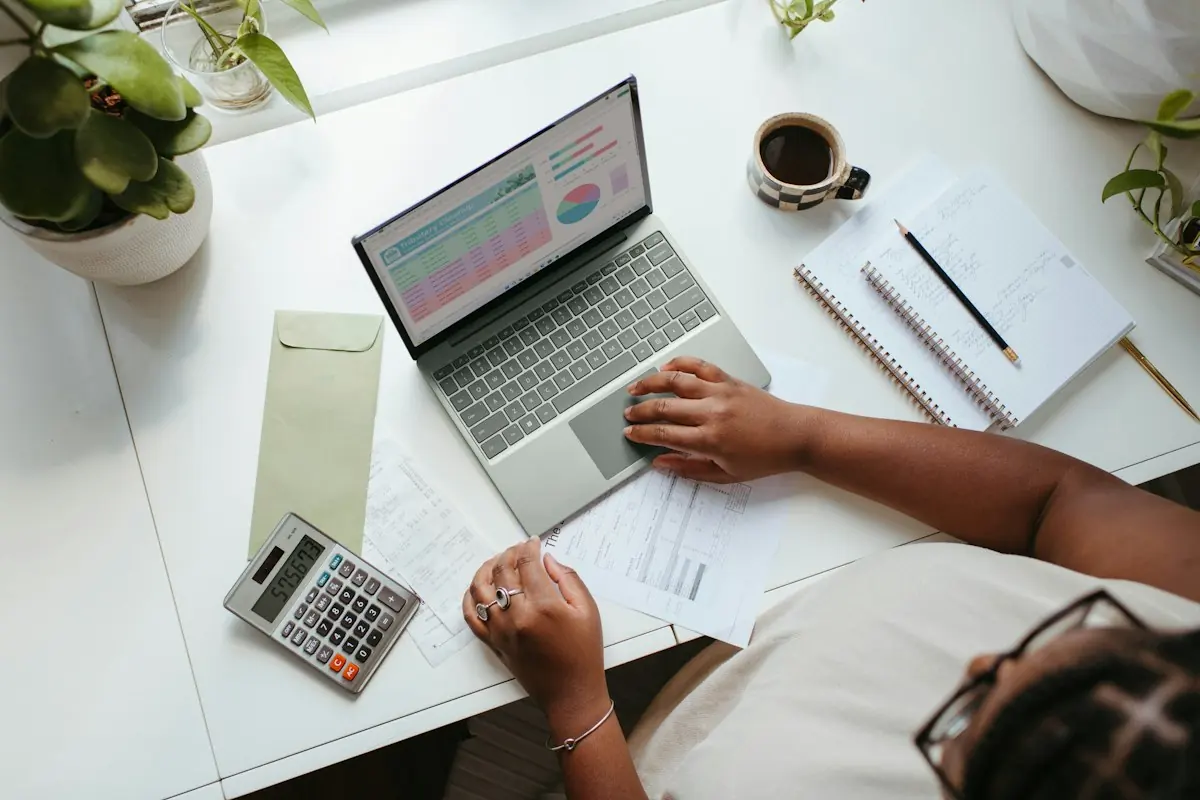 Business professional working at a table with a laptop
